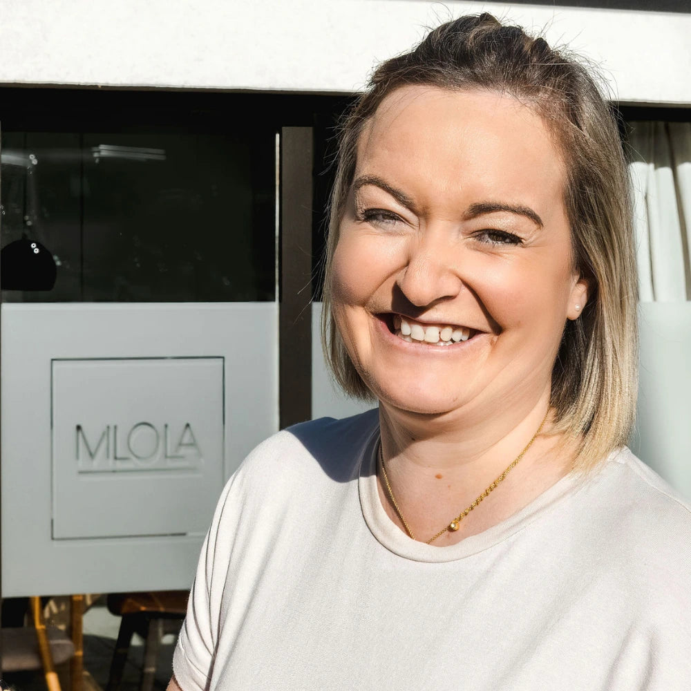 Charlotte smiling in front of Milola Showroom