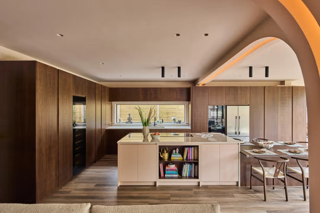 Modern kitchen with wooden walls, island, and appliances.